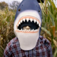 A man stands in a cornfield wearing a shark mask in the low-budget horror movie Sharks of the Corn.